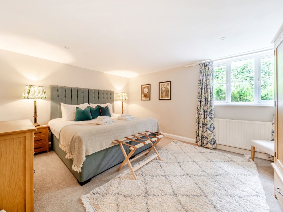 A bedroom with a bed and lamps at Hammerhole at the Graythwaite Estate near Hawkshead