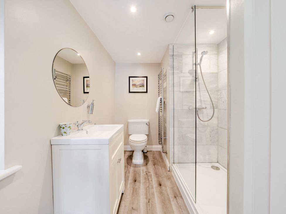 A bathroom with a sink, toilet, and shower at Hammerhole at the Graythwaite Estate near Hawkshead