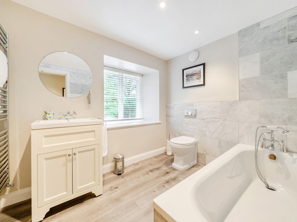 A bathroom with a bath and toilet at Hammerhole at the Graythwaite Estate near Hawkshead