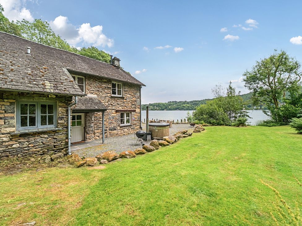An outdoor area with a house and lake at Hammerhole at the Graythwaite Estate Graythwaite Estate near Hawkshead