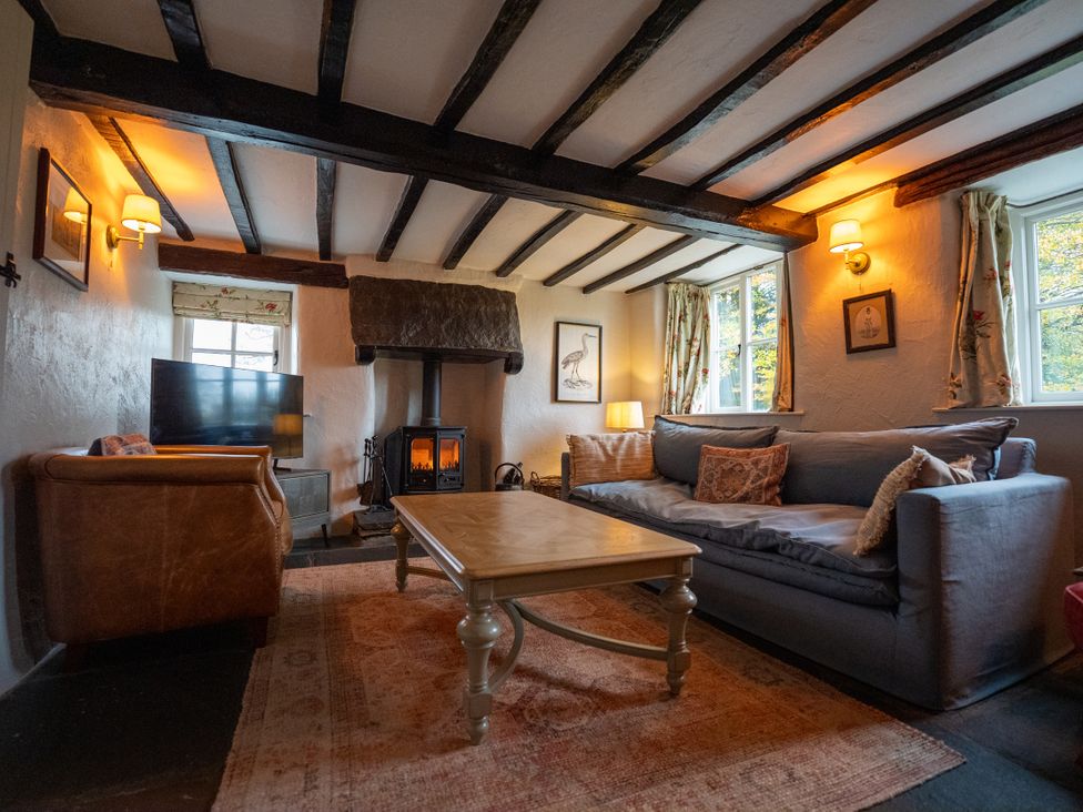 A living room with a sofa and coffee table at Hullet Hall in Graythwaite near Hawkshead