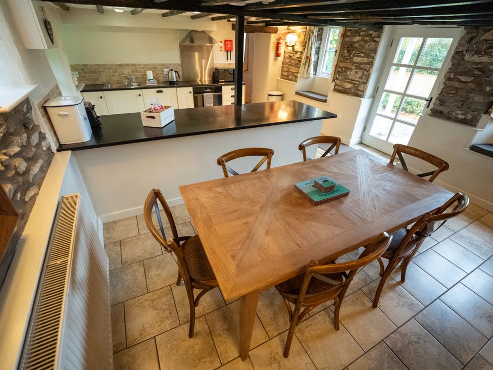 A dining room with a wooden table and chairs at Hullet Hall Graythwaite near Hawkshead
