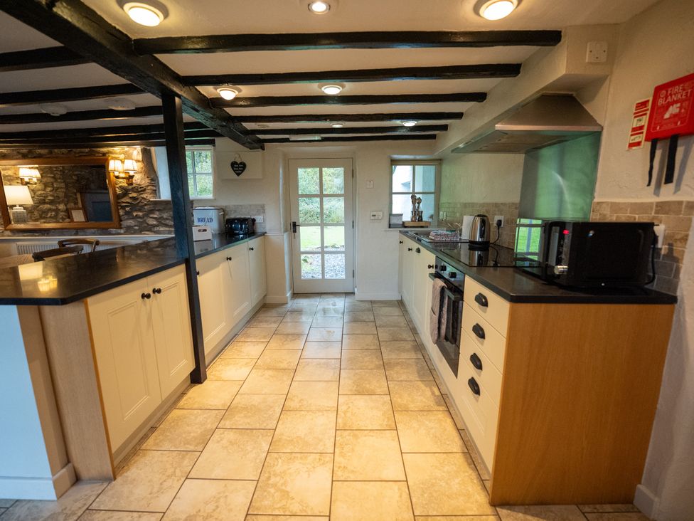 A kitchen with appliances and counters at Hullet Hall in Graythwaite near Hawkshead