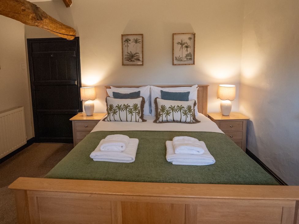 A bedroom with a bed and bedside tables at Hullet Hall in Graythwaite near Hawkshead