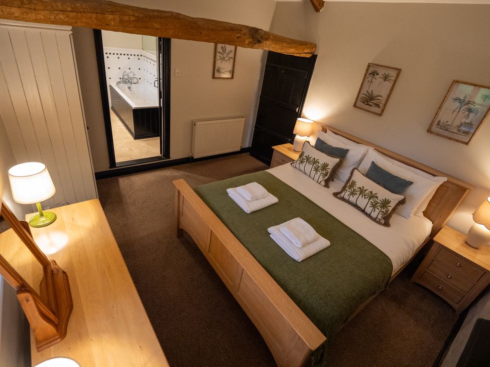 A bedroom with a bed and side table at Hullet Hall Graythwaite near Hawkshead