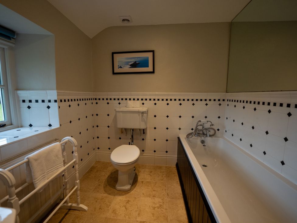 A bathroom with a bath and toilet at Hullet Hall in Graythwaite near Hawkshead