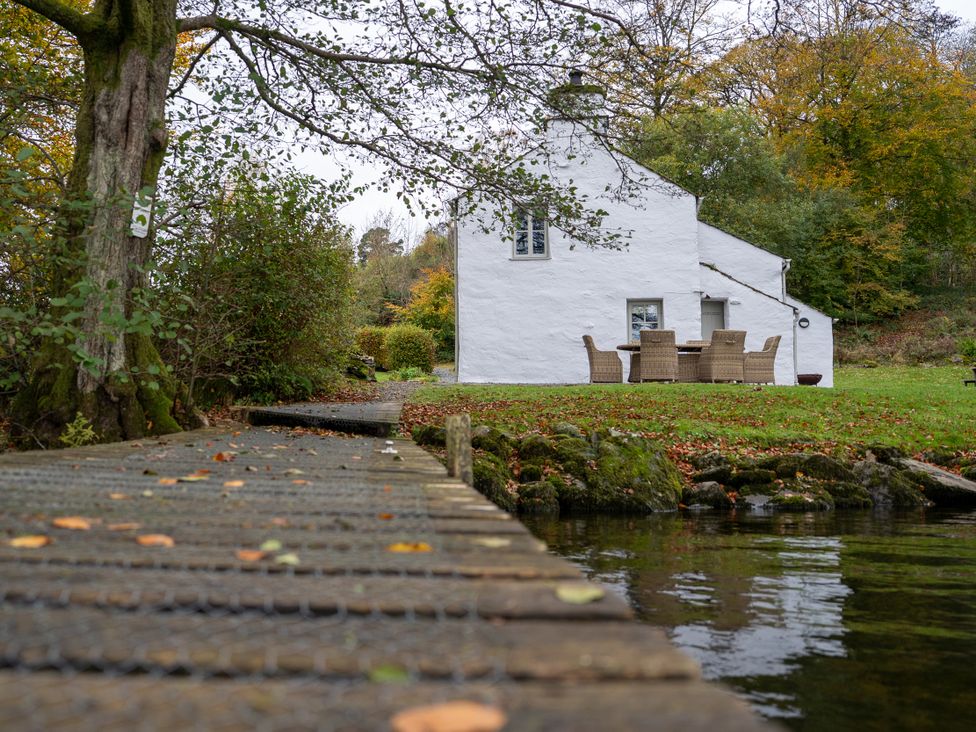 A house with dining area near water at Hullet Hall Graythwaite near Hawkshead