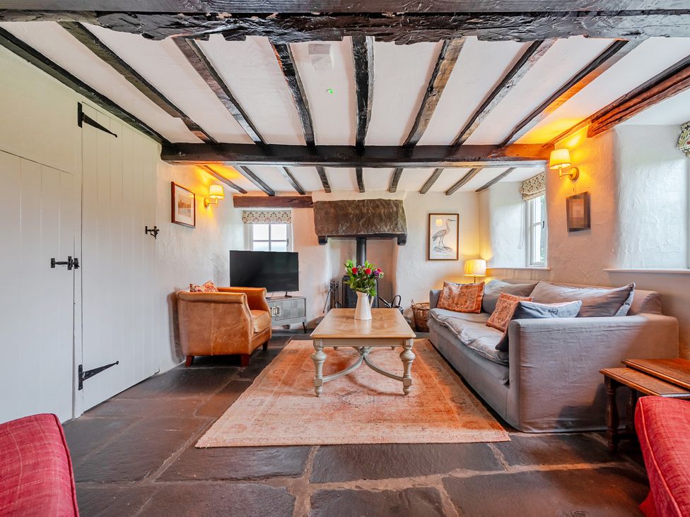 A living room with a sofa and coffee table at Hullet Hall at the Graythwaite Estate near Hawkshead