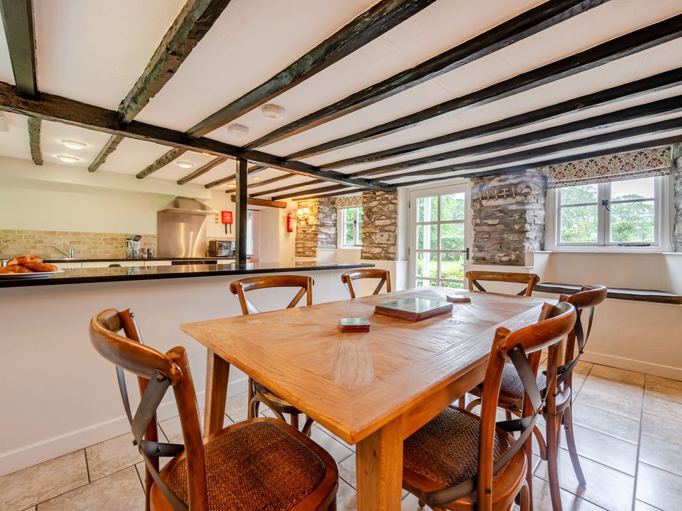 A dining room with a table and chairs at Hullet Hall at the Graythwaite Estate near Hawkshead