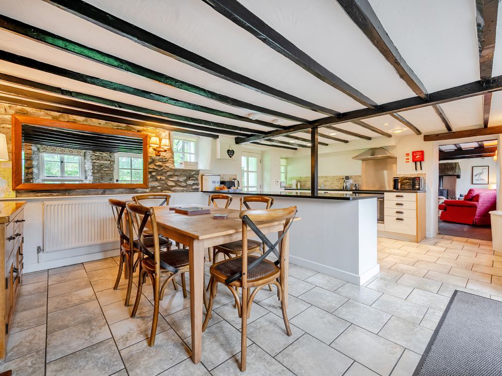A kitchen with a dining table and chairs at Hullet Hall at the Graythwaite Estate near Hawkshead