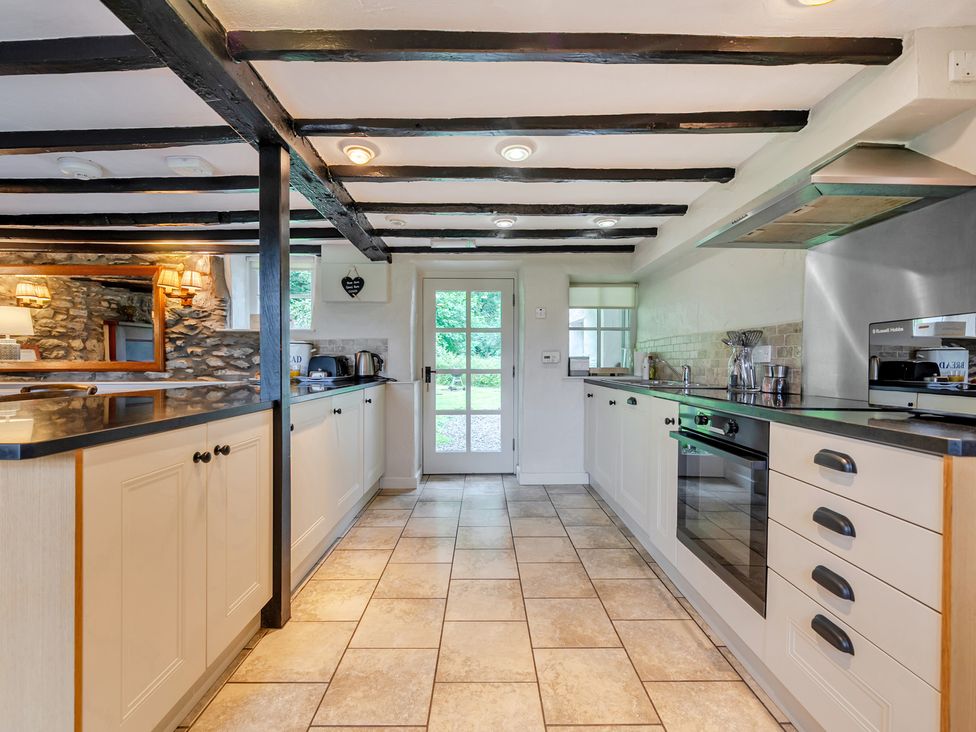 A kitchen with cabinets and appliances at Hullet Hall at the Graythwaite Estate near Hawkshead