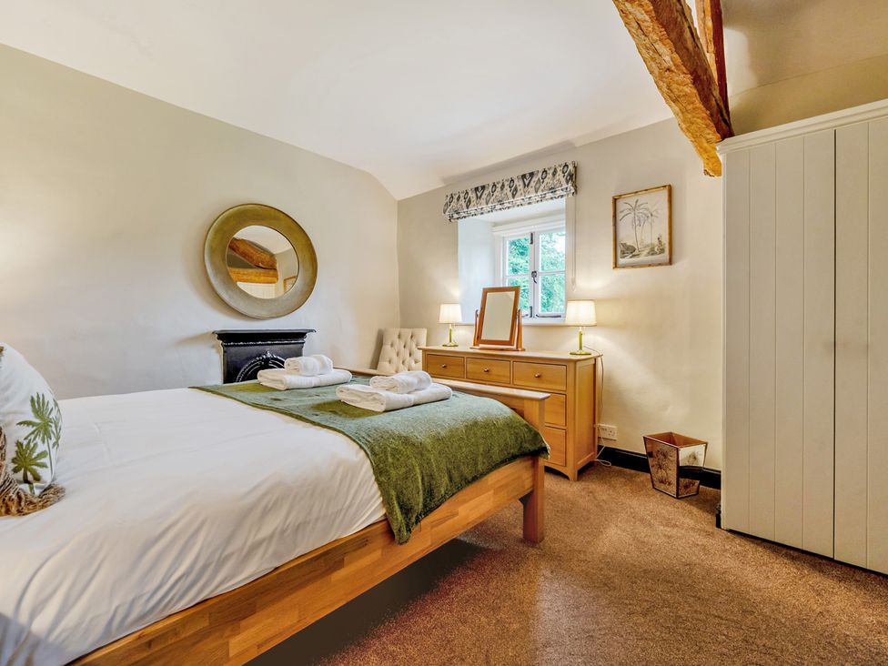 A bedroom with a bed and furniture at Hullet Hall at the Graythwaite Estate near Hawkshead