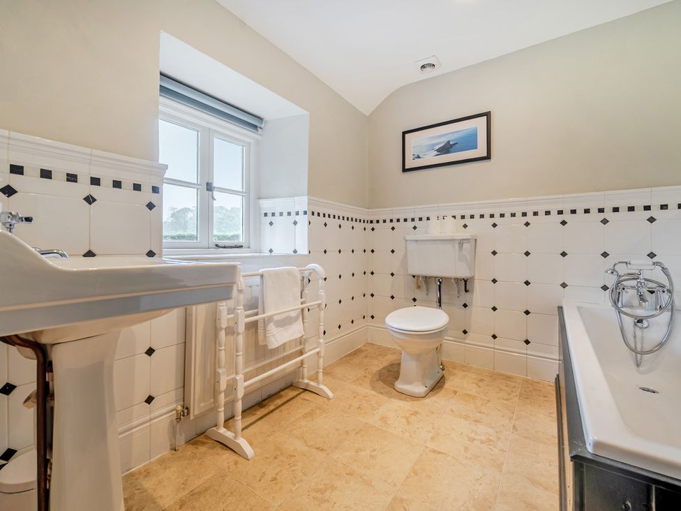 A bathroom with a sink, toilet, and bathtub at Hullet Hall at the Graythwaite Estate near Hawkshead