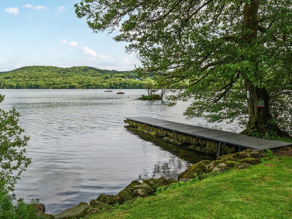 A view of a dock on water surrounded by trees at Hullet Hall at the Graythwaite Estate near Hawkshead