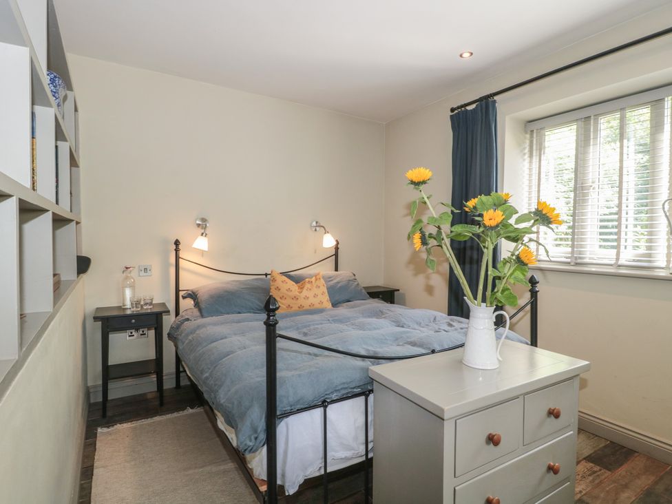 A bedroom with a bed and bedside table at The Stable Deepdean near Ross-on-Wye