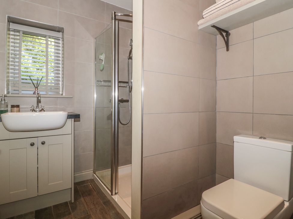 A bathroom with a sink, shower, and toilet at The Stable in Deepdean near Ross-on-Wye