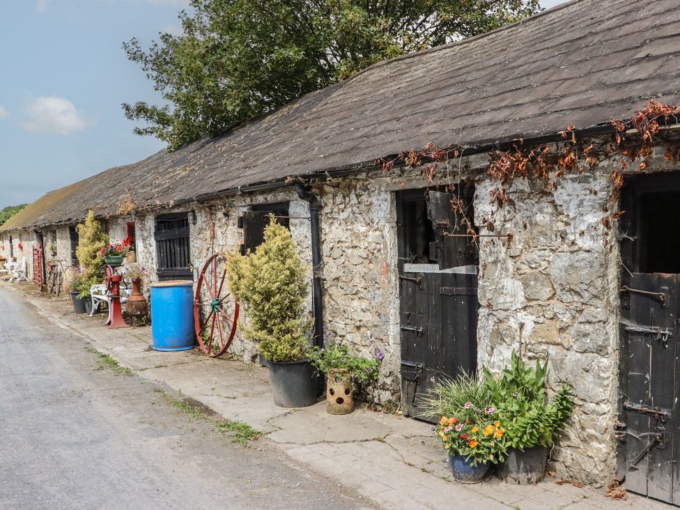An outdoor area with stone buildings and plants at Mrs Delaney's Loft in Ardfinnan near Clonmel, County Tipperary