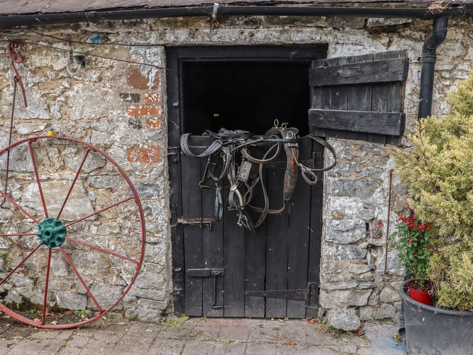 A barn door with harness and wagon wheel at Mrs Delaney's Loft Ardfinnan near Clonmel County Tipperary