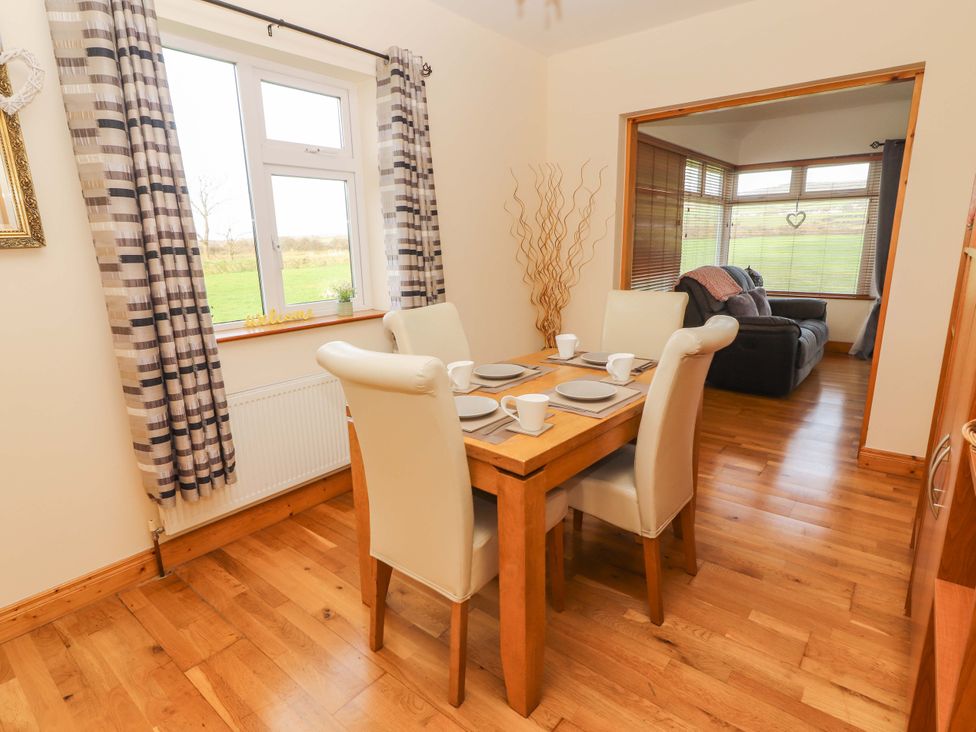A dining area with a table and chairs at Moybella Lodge in Lisselton near Ballybunion, County Kerry