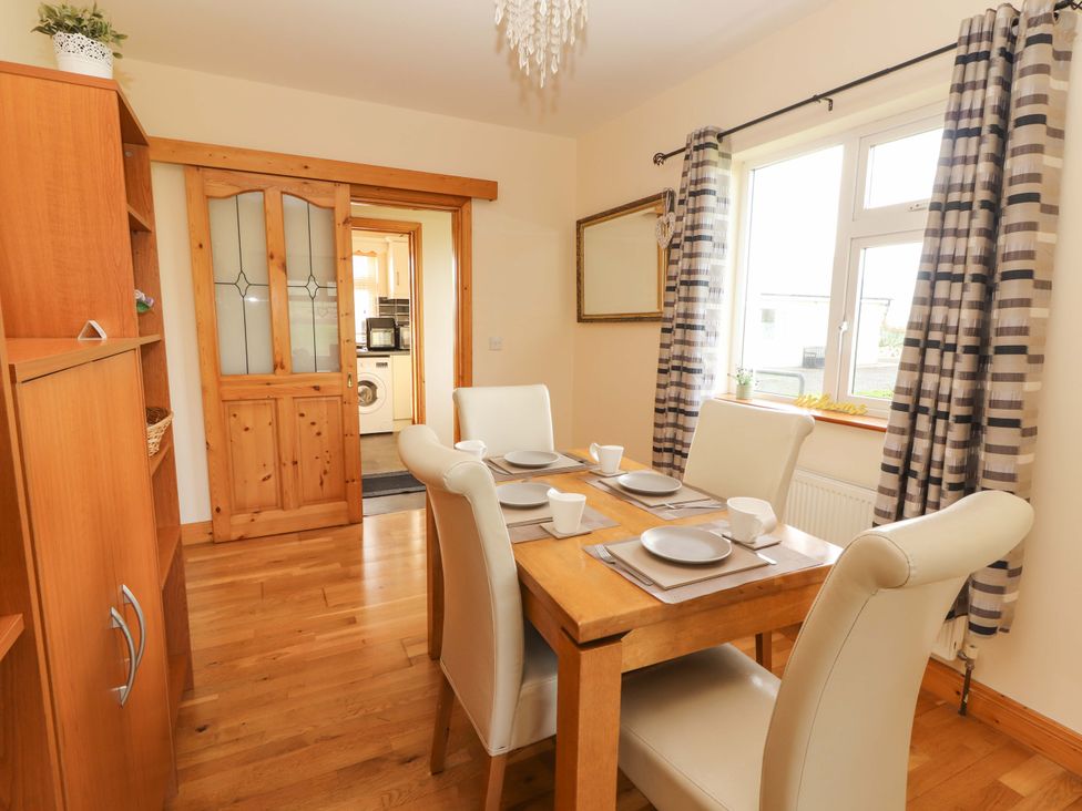 A dining room with a table and chairs at Moybella Lodge in Lisselton near Ballybunion, County Kerry