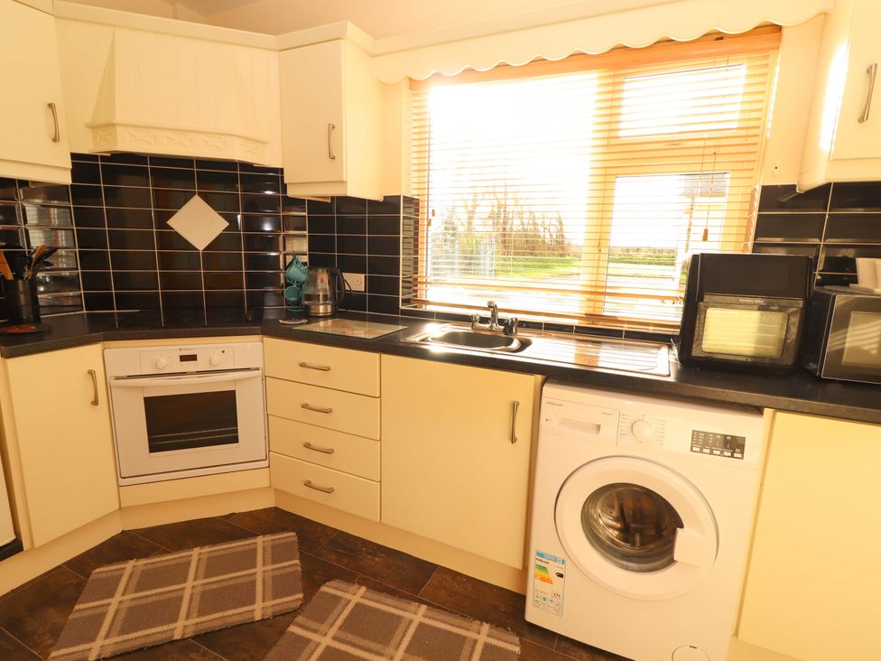 A kitchen with appliances and countertop at Moybella Lodge in Lisselton near Ballybunion, County Kerry