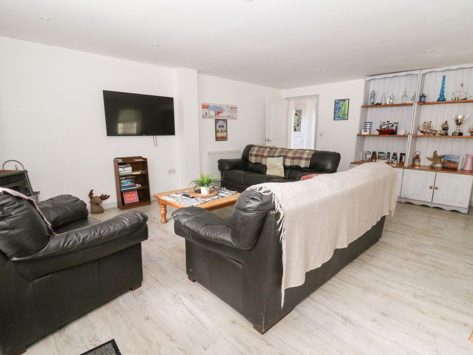 A living room with two sofas and a television at Cariad Cottage in Cross Inn
