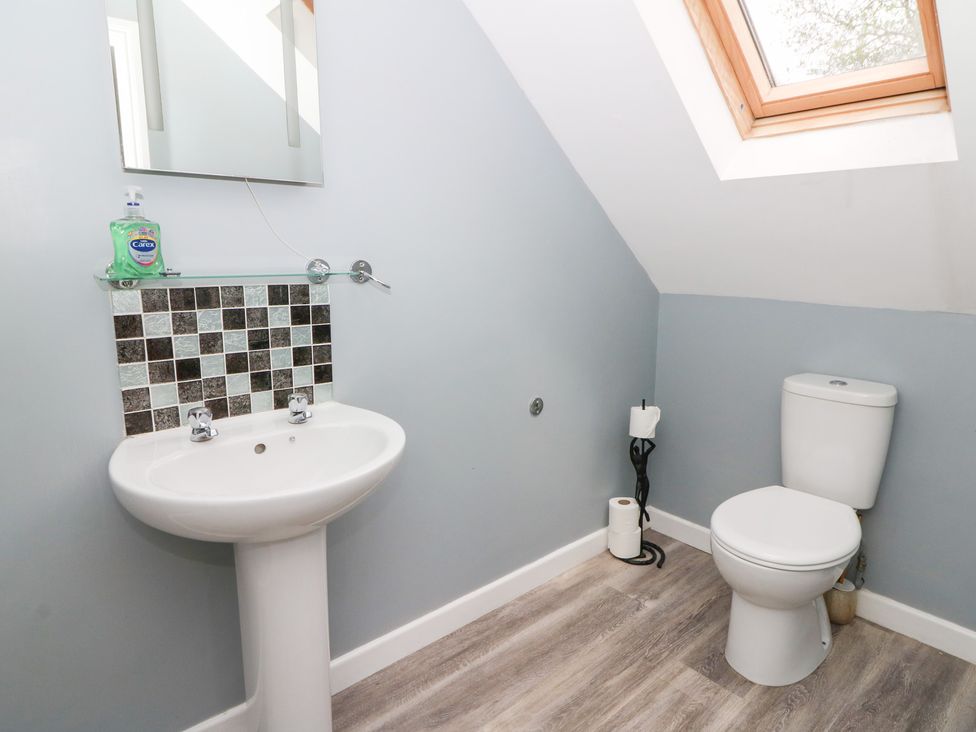 A bathroom with a sink and a toilet at Cariad Cottage in Cross Inn