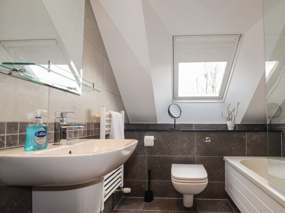 A bathroom featuring a sink, toilet, and bathtub at Little Chestnut in Muir of Ord