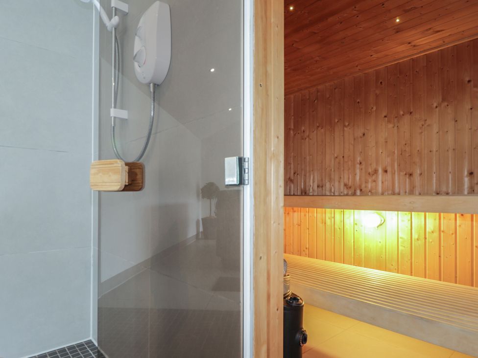 A shower area and a sauna at Little Chestnut in Muir of Ord