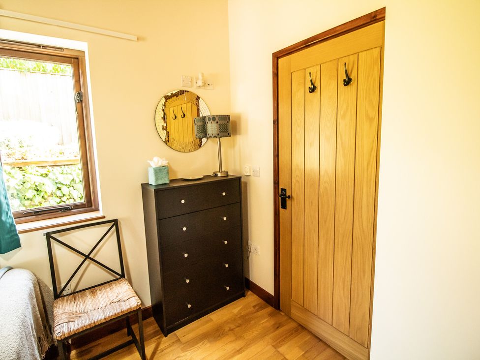 A bedroom with a window and furniture at Sycamore Lodge Nantmel near Rhayader