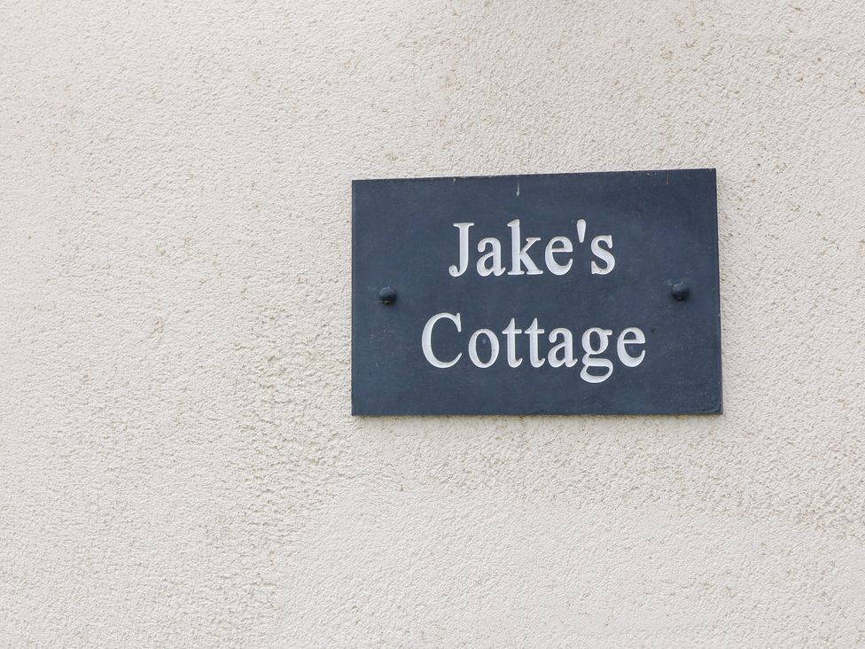 A sign displaying the name Jake's Cottage in Langrick near Boston