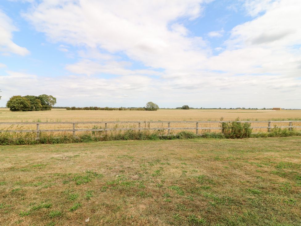 An outdoor view of a field and trees at Jake's Cottage in Langrick near Boston