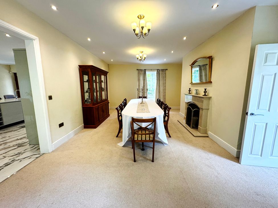 A dining room with a table and chairs at Plas Glyndwr Crickhowell