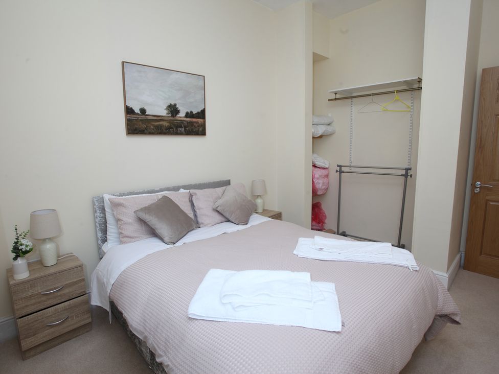 A bedroom with a bed and bedside table at Plas Glyndwr in Crickhowell