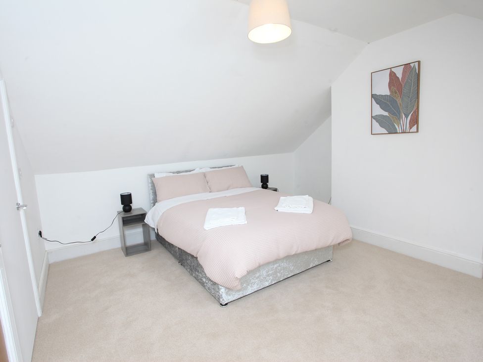 A bedroom with a bed and bedside table at Plas Glyndwr in Crickhowell