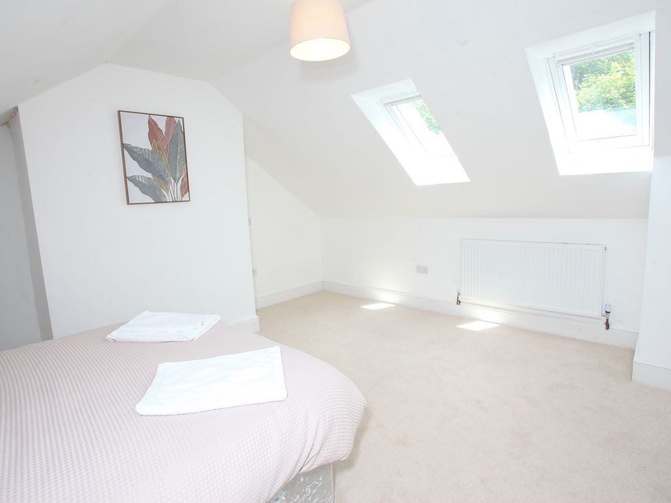 A bedroom with a bed and skylights at Plas Glyndwr in Crickhowell
