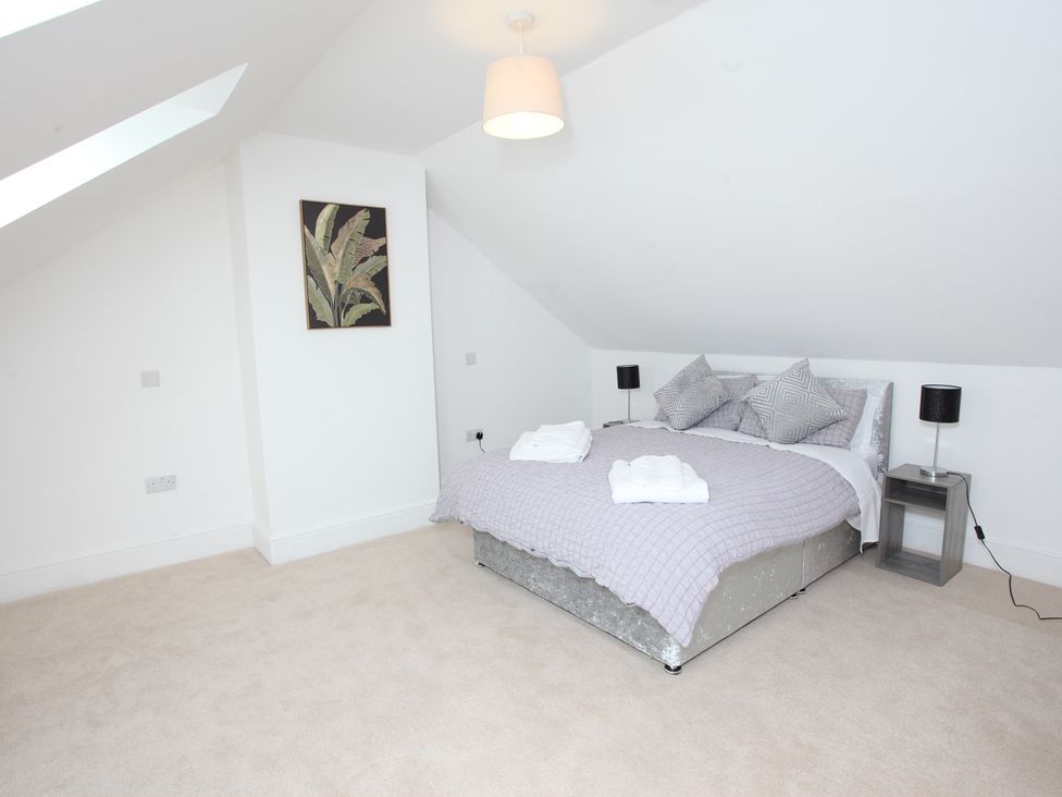 A bedroom with a bed and wall art at Plas Glyndwr in Crickhowell
