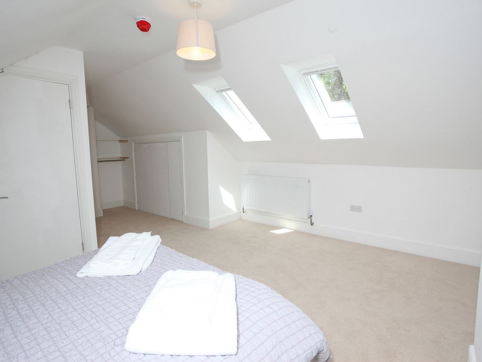 A bedroom with a bed and skylight at Plas Glyndwr in Crickhowell
