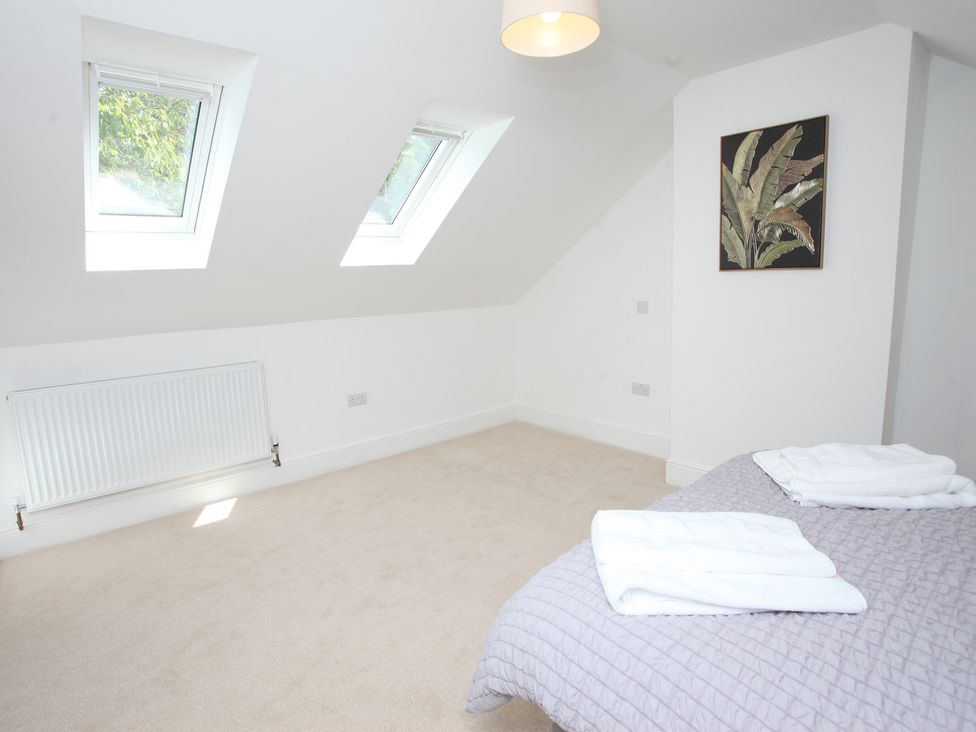 A bedroom with a bed and towels at Plas Glyndwr in Crickhowell