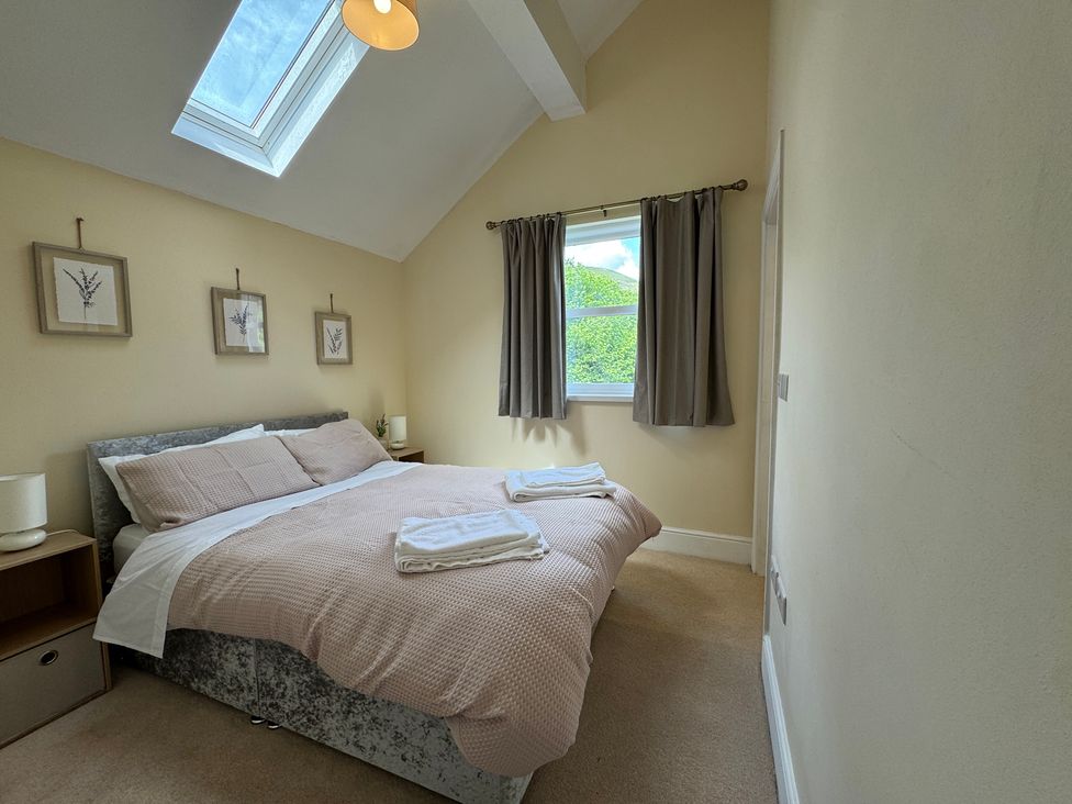A bedroom with a bed and a window at Plas Glyndwr in Crickhowell