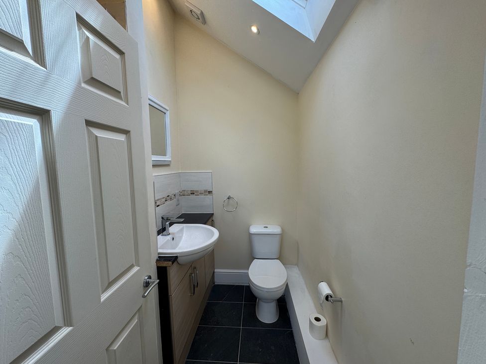 A bathroom with a sink and toilet at Plas Glyndwr in Crickhowell