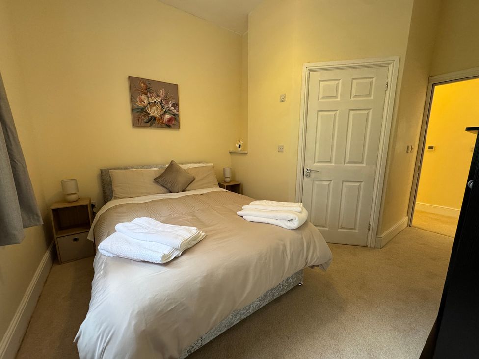 A bedroom with a bed and bedside table at Plas Glyndwr in Crickhowell