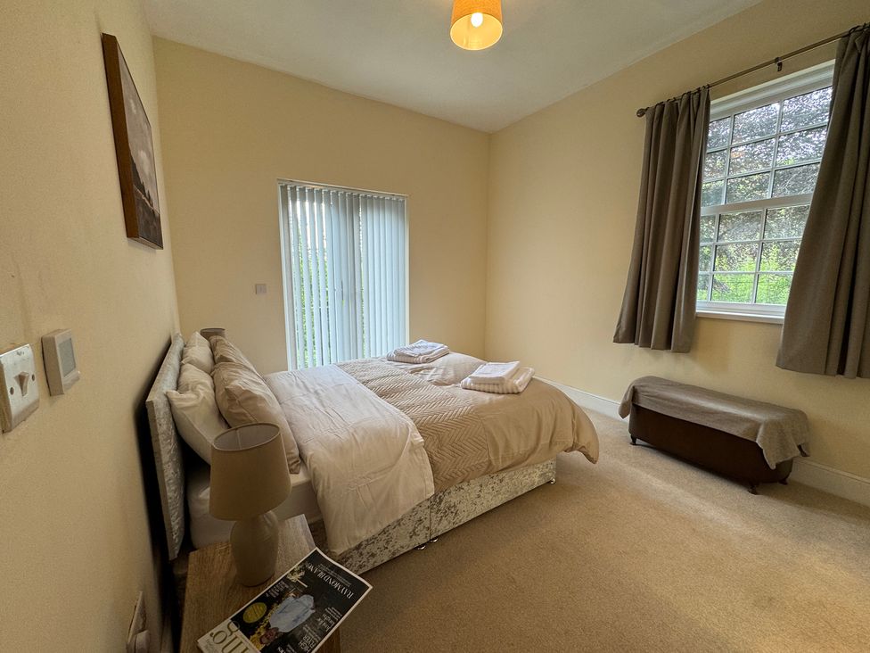A bedroom with a bed and a window at Plas Glyndwr in Crickhowell