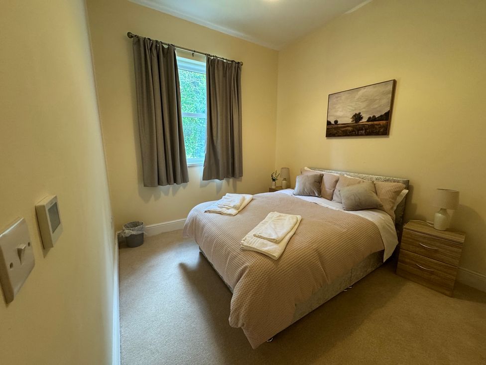 A bedroom with a bed and nightstand at Plas Glyndwr in Crickhowell
