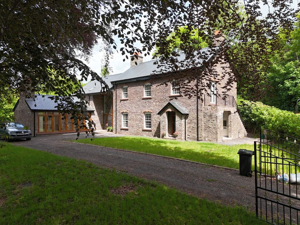 A house with car and garden in front at Plas Glyndwr in Crickhowell