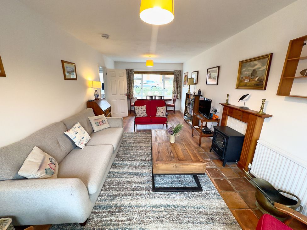 A living room with a sofa, table, and television at 38 Dale End Brancaster Staithe near Burnham Market