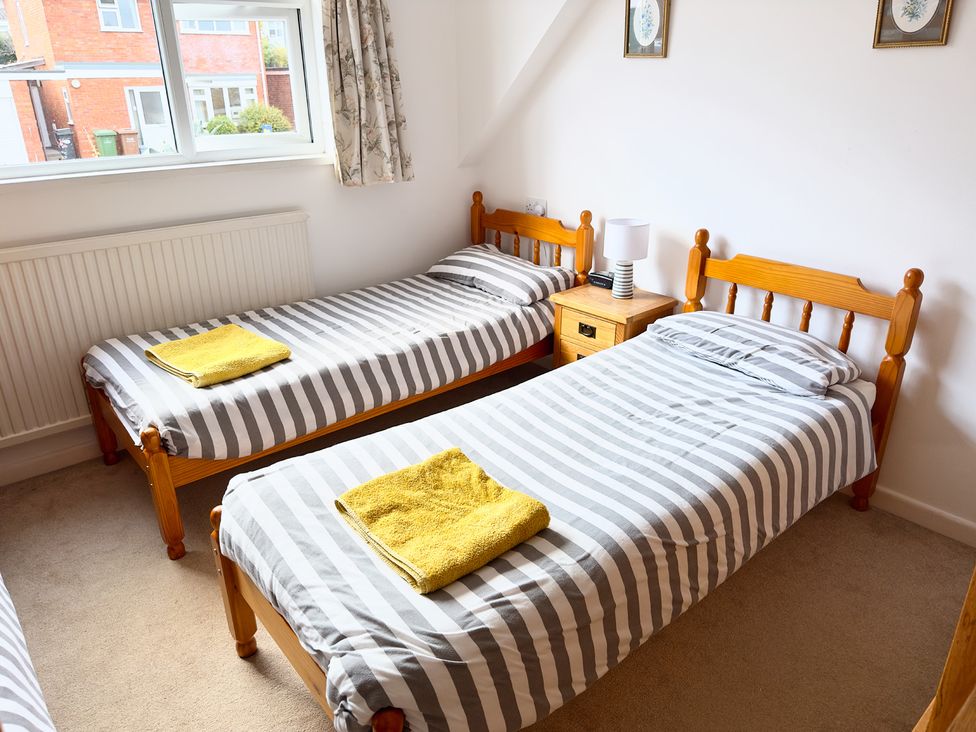 A bedroom with two single beds and a nightstand at 38 Dale End Brancaster Staithe near Burnham Market