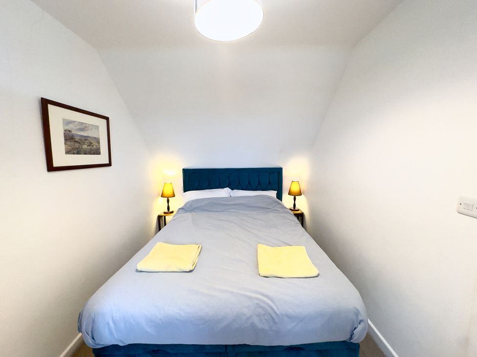 A bedroom with a double bed and bedside lamps at 38 Dale End Brancaster Staithe near Burnham Market