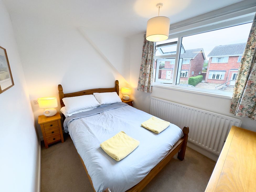 A bedroom with a bed and bedside table at 38 Dale End Brancaster Staithe near Burnham Market