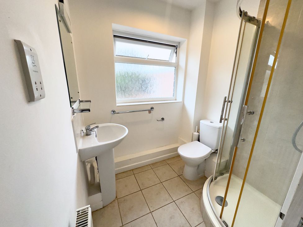 A bathroom with a sink, toilet, and shower at 38 Dale End Brancaster Staithe near Burnham Market